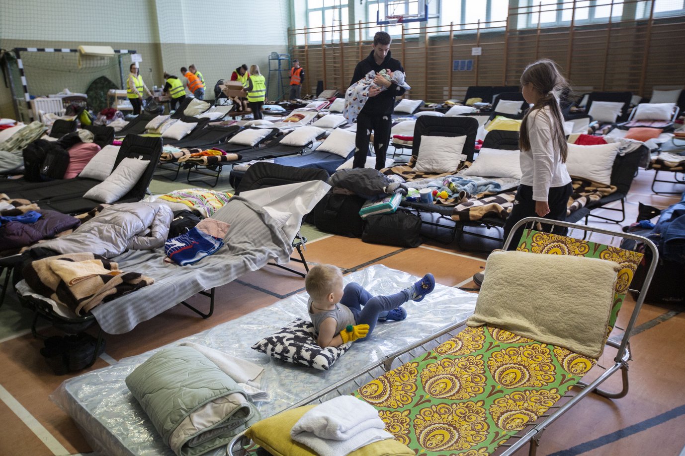 Refugees from Ukraine warm up in the reception center in Medyka