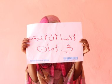 Nineteen-year-old Rumaysa from the host community holds up a sign saying "I want to live in safety” during the UNHCR campaign against human trafficking in east Sudan.